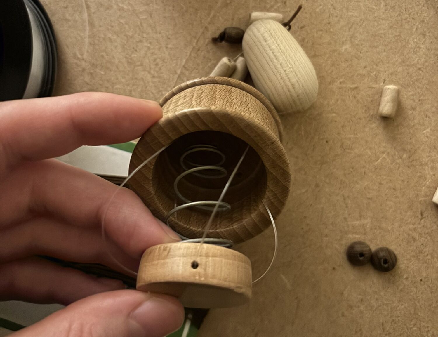 Hands crafting wooden piece in sunlight