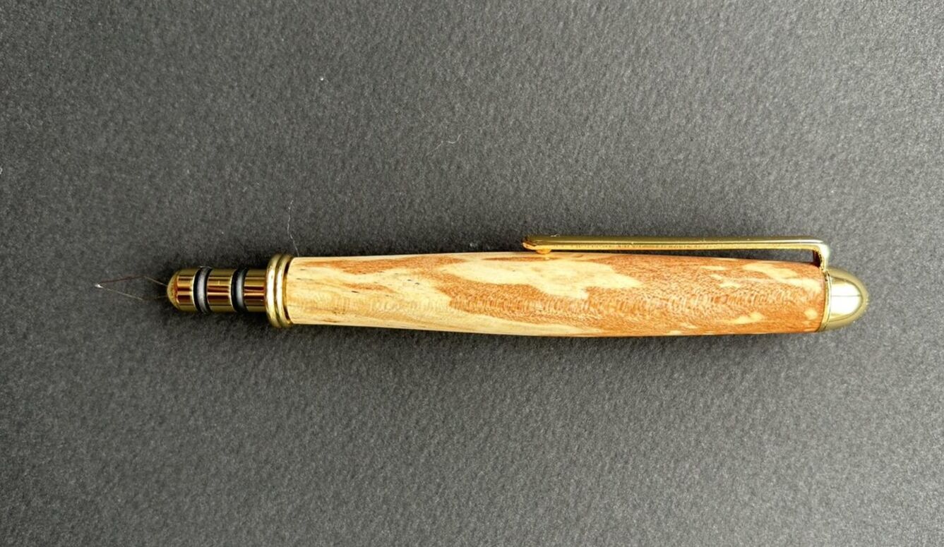 Artisan using lathe in woodworking workshop